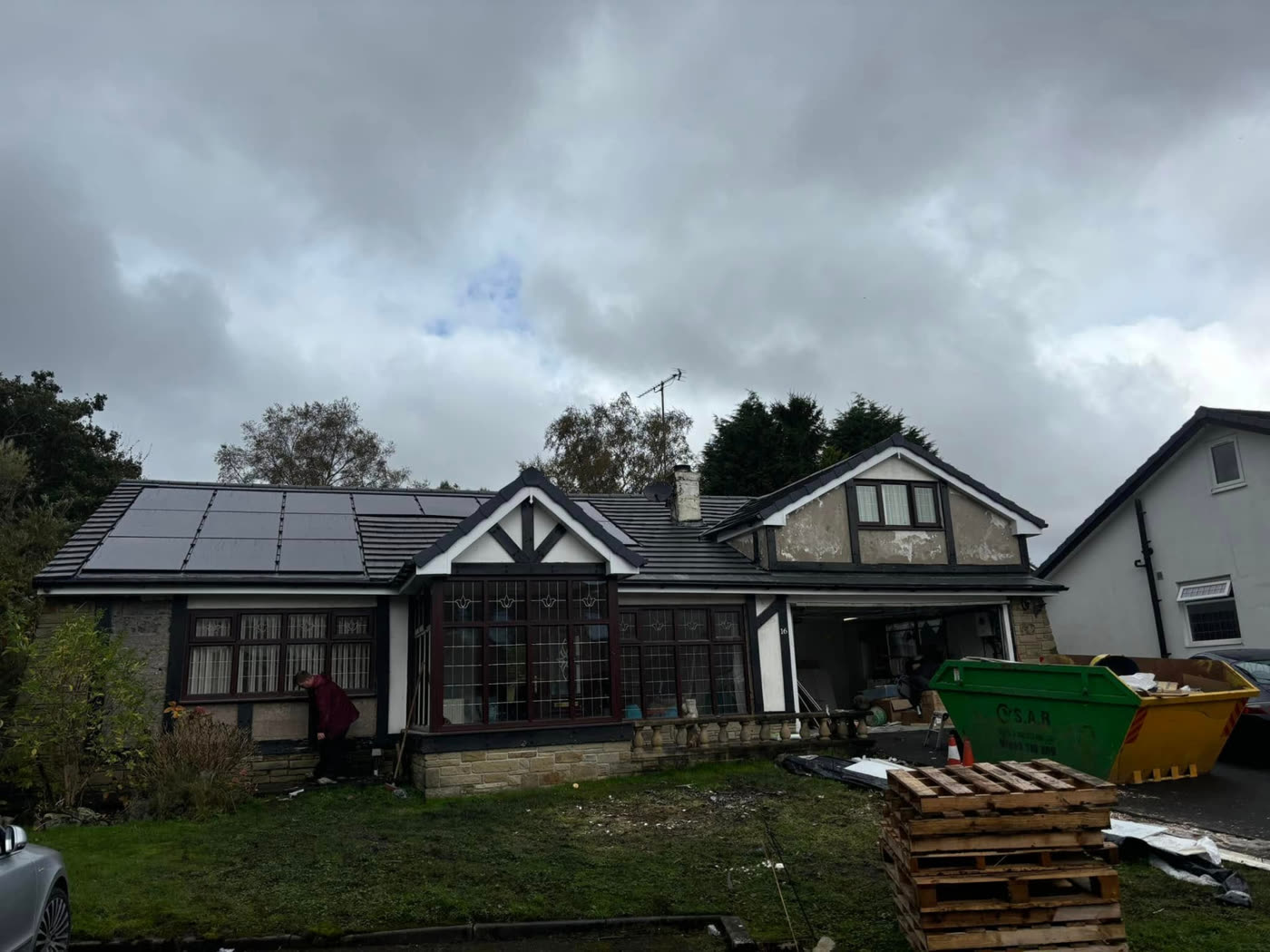 Dormer bungalow re-roofed in anthracite tiles with the original solar panels refitted