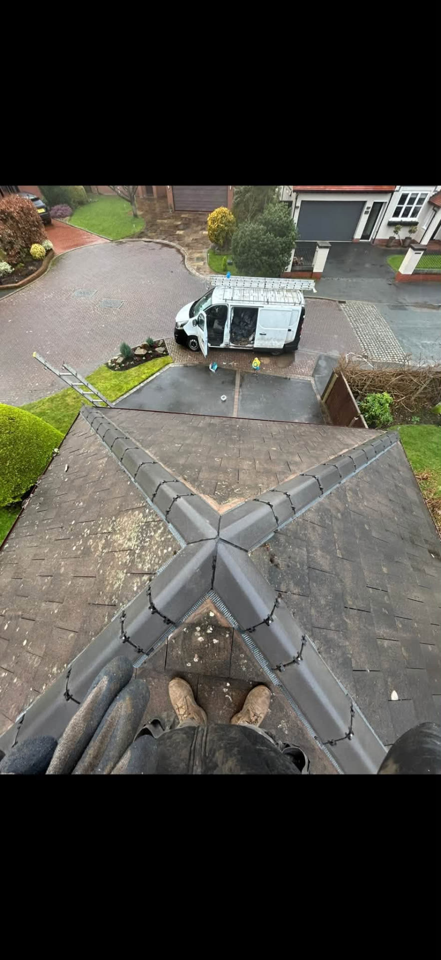 Hips and ridge of a detached house roof re-set with a dry fix system, seen from above